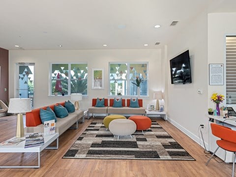 a living room with couches and chairs and a television